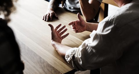 Friends around a table talking